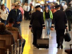 Two British Airways Pilots walking through departures of Terminal 5 at Heathrow Airport (Steve Parsons/PA)