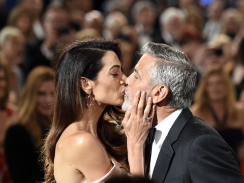 George Clooney gets a kiss from his wife Amal as he arrives for the 46th AFI Life Achievement Award (Chris Pizzello/Invision/AP)