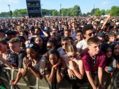 Festivalgoers observe a minute’s silence (Matt Crossick/PA)