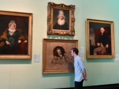 A member of staff studies Sir Thomas Laurence’s portait of William Wilberforce at the National Portrait Gallery in London (John Stillwell/PA)