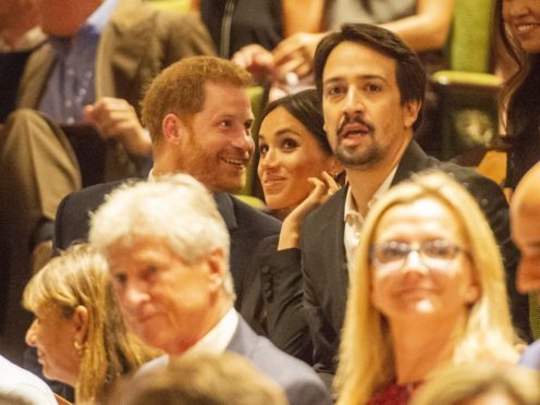 The Duke and Duchess of Sussex take their seats next to Lin-Manuel Miranda (Dan Charity/The Sun)