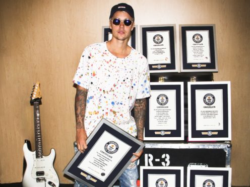 Justin Bieber with eight of his official Guinness World Records certificates (GWR/PA)