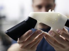 Cody Wilson holds a 3D-printed gun called the Liberator (Eric Gay/AP)