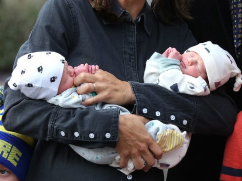 Chris Evans and his wife, Natasha, leave Frimley Park Hospital in Surrey with their twins, named Ping and Pong (Jonathan Brady/PA)