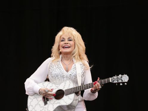 Dolly Parton has said humour is the secret of her 52-year marriage to Carl Dean (PA)