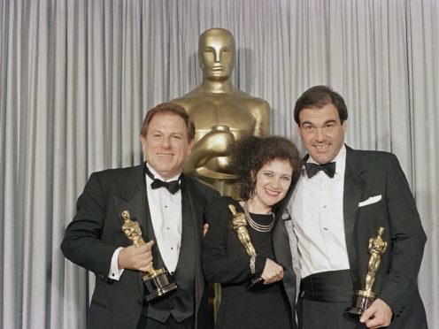 Claire Simpson, Arnold Kopelson, left, and Oliver Stone, after receiving their Oscars (Lennox McLendon/AP)