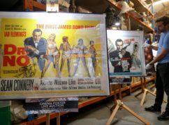 A poster for the 1962 Bond film Dr No alongside a poster for the 1963 James Bond film From Russia with Love, adjusted by Prop Store employee Matt Storey (Andrew Matthews/PA Wire)