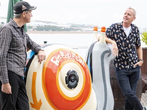 Fatboy Slim with the mix tape-themed snail he sponsored for the charity art trail in Brighton and Hove ( Liz Finlayson/Vervate/PA)
