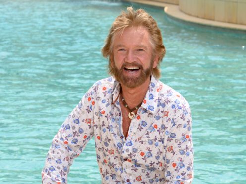 Noel Edmonds poses by the pool after being the first campmate evictedfrom the jungle (James Gourley/ITV/REX/Shutterstock)