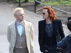 Michael Sheen (white coat) with co-star David Tennant (red hair) as they film a scene from Good Omens (John Stillwell/PA)