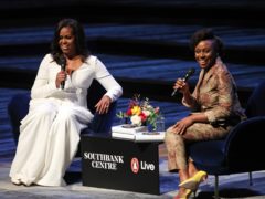 Michelle Obama (left) in conversation with writer Chimamanda Ngozi Adichie (PA)