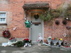 Floral tributes are left outside the home of George Michael in Goring-on-Thames, Oxfordshire (Steve Parsons/PA)