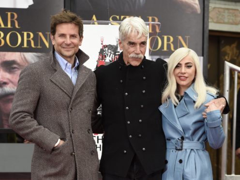 Bradley Cooper, left, and Lady Gaga, right, pose with actor Sam Elliott during a hand and footprint ceremony honouring Elliott (Chris Pizzello/Invision/AP)