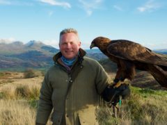 Jules Hudson with a golden eagle (BBC)