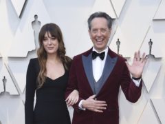 Richard E Grant and Bradley Cooper among stars with family members at the Oscars (Richard Shotwell/AP)