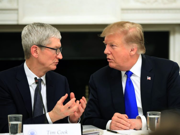 President Donald Trump talks to Apple boss Tim Cook during meeting in tt the White House (Manuel Balce Ceneta/AP)