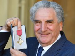Jim Carter holds his OBE following an investiture ceremony at Buckingham Palace (John Stillwell/PA)
