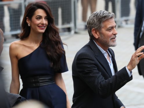 George and Amal Clooney were representing the Clooney Foundation for Justice (Andrew Milligan/PA)