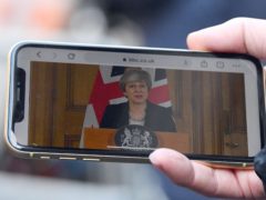 A journalist in Downing Street, London watches Prime Minister Theresa May making a statement following a cabinet meeting. (Victoria Jones/PA)