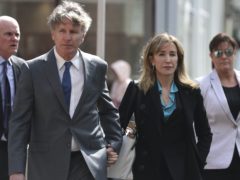 Actress Felicity Huffman arrives at court holding hands with her brother Moore Huffman Jr to face charges in a nationwide college admissions bribery scandal (AP Photo/Charles Krupa)