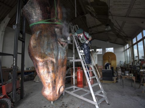 British Sculptor Nic Fiddian-Green puts the finishing touches to his new 6m high copper horse in his Surrey studio, before it is transported to Venice in Italy for the Biennale Art fair, which runs from May 1 to July 31.