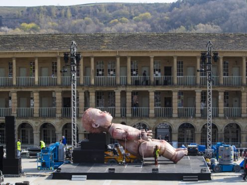 A giant mechanical baby is installed ahead of Mind the Gap Theatre Company’s first performance of ZARA at the Halifax Piece Hall, Yorkshire.