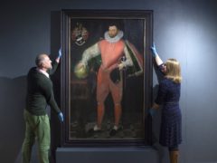 National Trust staff with the portrait of Sir Francis Drake (National Trust/PA)