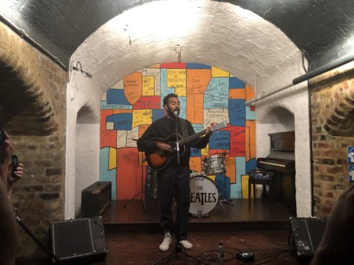 Himesh Patel, star of new Danny Boyle and Richard Curtis film Yesterday, performs on stage in a replica of The Cavern Club at The Beatles Story in Liverpool (Eleanor Barlow/PA)