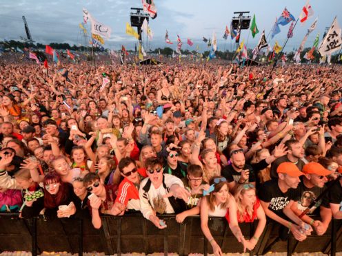 Festivalgoers watch the Pyramid Stage at Glastonbury Festival (Ben Birchall/PA)