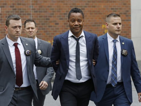 Actor Cuba Gooding Jr being led by police officers in New York (Mark Lennihan/AP)