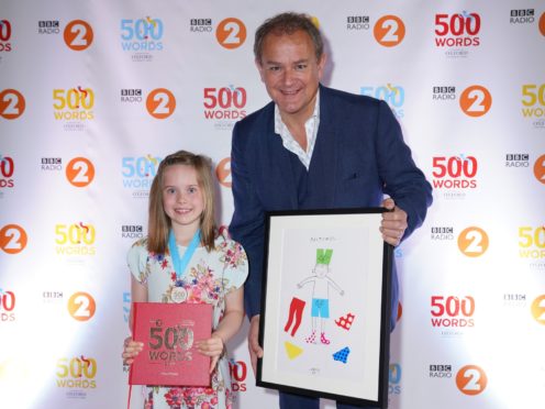 Mya Dainty and celebrity reader Hugh Bonneville at the 500 Words final (Kieron McCarron/BBC/PA)