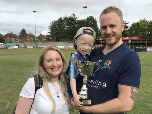 Archie Wilks with his parents Simon and Harriet (Beverley Rouse/PA)