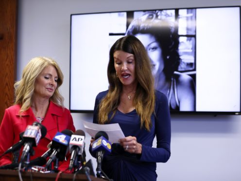 Janice Dickinson speaks at a press conference, announcing a settlement of her defamation lawsuit against comedian Bill Cosby (Katherine Campione/AP)