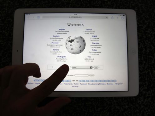 A person looking at Wikipedia on their iPad (Peter Byrne/PA)