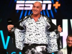 Tyson Fury shows off his shirt which has drawings of former world heavyweight champions on it during the press conference at BT Sport Studio, London (Kirsty O’Connor/PA)