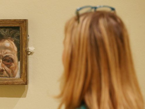A gallery employee looks at Self Portrait With A Black Eye by Lucian Freud during a preview of Lucian Freud: The Self-portraits exhibition at the Jillian and Arthur M. Sackler Wing of Galleries, Royal Academy of Arts, London (Jonathan Brady/PA)