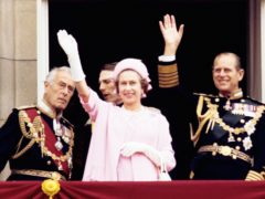 Earl Mountbatten of Burma, Queen Elizabeth II and the Duke of Edinburgh wave from the balcony of Buckingham Palace after the Silver Jubilee procession (PA)