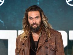 Jason Momoa feeds a bear a biscuit from his mouth in the footage (Matt Crossick/PA)