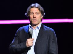 John Bishop said his wife had attempted to pull his piercing out several times (Matt Crossick/PA)