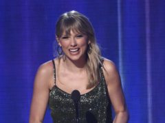 Taylor Swift toasted her fans as she was named artist of the decade at the American Music Awards (Chris Pizzello/Invision/AP)