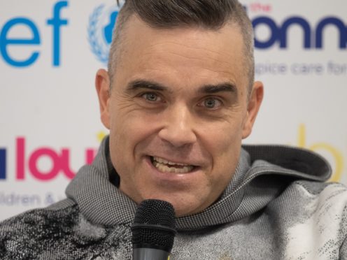 Robbie Williams, speaks during a press conference (Joe Giddens/PA)