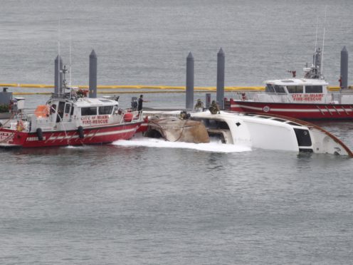 Miami Fire Rescue officials on the scene where the yacht caught fire (AP/Lynne Sladky)