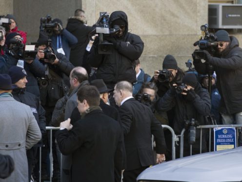 Harvey Weinstein, centre, walks by the media on his way into a Manhattan courthouse (Mark Lennihan/AP)