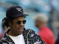 Jay-Z has denied he and wife Beyonce were staging a protest when they stayed seated during the national anthem at the Super Bowl (AP Photo/David J. Phillip)