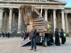BP or Not BP? activist Phil Ball stands with a Trojan horse that he designed, in front of the British Museum (Isobel Frodsham/PA)