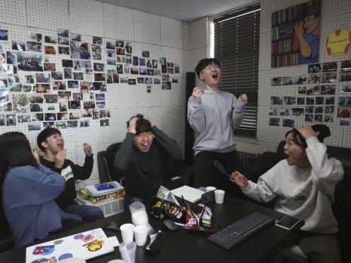 Film club members at a university in Seoul celebrate as they watch a live broadcast of South Korean director Bong Joon Ho’s Parasite receiving the award for best picture at the Oscars (Ahn Young-joon/AP)