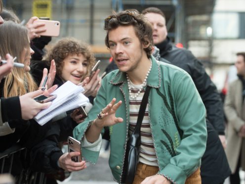 Harry Styles speaks with fans as he leaves Wogan House in London after an appearance on Radio 2’s The Zoe Ball Breakfast Show (David Mirzoeff/PA)