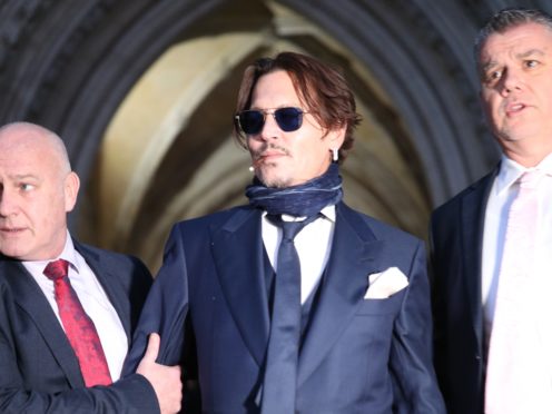 Actor Johnny Depp (centre) leaving the High Court in London after attending a hearing in his libel case against the publishers of The Sun and its executive editor, Dan Wootton (Yui Mok/PA)