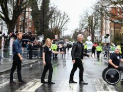 The Duke of Sussex, Jon Bon Jovi and members of the Invictus Games Choir walk on the famous zebra crossing outside the Abbey Road Studios in London (Hannah McKay/PA)