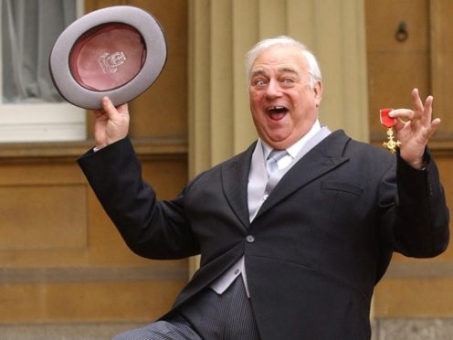 Comedian Roy Hudd holds his OBE for services to entertainment (Stefan Rousseau/PA)